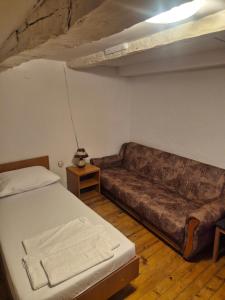 a living room with a couch and a bed at Lila apartments in Bijakovići