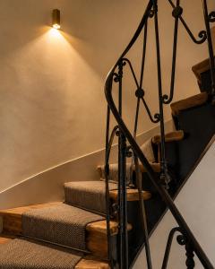 a set of stairs with a light on the ceiling at Hôtel Derby Eiffel in Paris