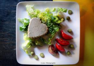 a white plate with a sandwich and vegetables on it at Du puits de Riquier écologique in Régusse +6 photos