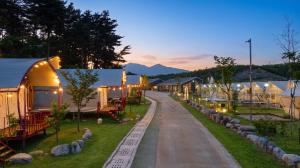 a row of tents with lights on a street at Sokcho Night Sky Pension in Sokcho