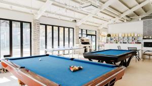 a billiard room with a pool table and two tables at Sokcho Night Sky Pension in Sokcho