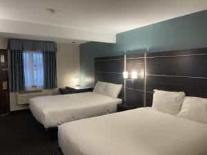 a hotel room with two beds and a window at Landmark Inn in Osawatomie
