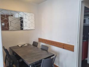 a dining room table with chairs and a mirror at Appartement 2 pièces rénové 5 pers. au cœur des pistes - FR-1-181-952 in Plagne Bellecote +8 photos