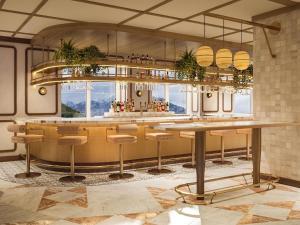 a bar with a table and chairs in a room at Rimrock Banff, Emblems Collection in Banff