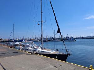 a sailboat is docked at a dock in the water at Satori in Władysławowo +24 photos