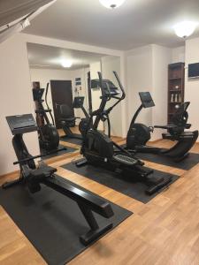 a gym with several treadmills and elliptical machines at Hotel Restauracja Cztery Pory Roku in Orneta