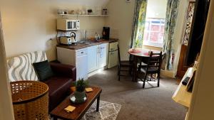 a small living room with a couch and a table at Mews Apartments in Lincoln