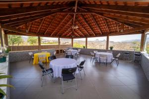 a dining area with tables and chairs on a roof at Hotel Cantinho in Montanha