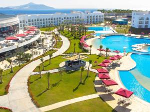 an aerial view of a resort pool with umbrellas at Rixos Radamis Sharm El Sheikh in Sharm El Sheikh