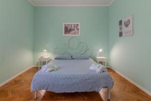 a bedroom with a bed with two pillows on it at Residenza Paradisea in Arezzo