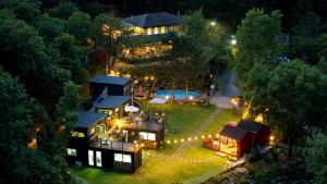 an aerial view of a house with a pool at night at Gapyeong Ruba Pension in Gapyeong +12 photos