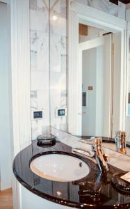 a bathroom with a sink and a mirror at L'échelle Rouge in Cannes +31 photos