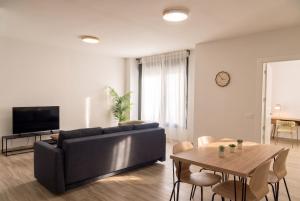 a living room with a couch and a table at InsideHome Ciudad de Valladolid in Valladolid