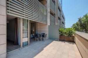 a balcony with a table and chairs on a building at Arrels d'Emporda in Palafrugell