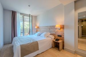 a bedroom with a large bed and a window at Arrels d'Emporda in Palafrugell +64 photos