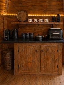 a counter with pots and pans on top of it at Glamp and Tipple Ltd in Great Ellingham