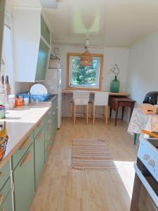 a kitchen with a table and a dining room at Vakker perle nær sjøen in Villanger