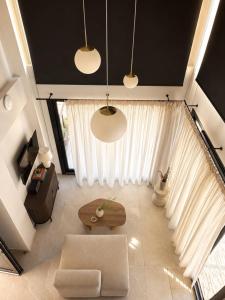a living room with a couch and a table at athanasia sea view home front house in Polychrono +3 photos
