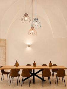a dining room with a table and chairs at Dimora Storica Palazzo Didonna in Rutigliano
