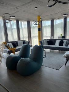 a living room with blue chairs and a couch at L&A Apartments in Dragash