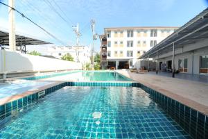 a swimming pool with blue tiles on a building at Nanya Hotel Chiang Mai in Chiang Mai