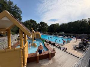 a group of people in a pool at a theme park at Chalet Riviera in Autruy-sur-Juine