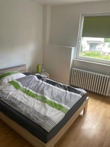 a bed in a room with a window at Pension am Schottenring in Schotten