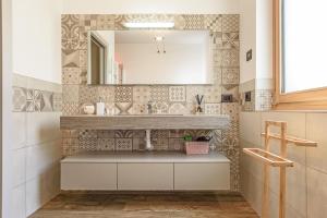 a bathroom with a sink and a mirror at Alpine Aura Loft- Privacy, Relax, Mountain View in Saint-Christophe +62 photos