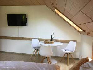 a room with a table and two chairs and a tv at Ferienhaus Barth in Bad Salzungen