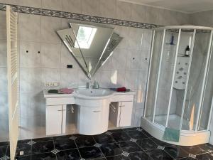 a bathroom with a sink and a shower at Ferienhaus Barth in Bad Salzungen +55 photos