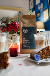 a table with a bag of coffee and a plate of food at Leśniczówka Dobrocin in Małdyty
