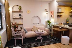 a living room with a couch and a table at The General's House - Tranquility Garden Villa in Hanoi +33 photos