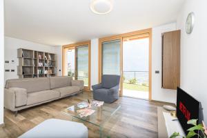 a living room with a couch and a glass table at Alpine Aura Loft- Privacy, Relax, Mountain View in Saint-Christophe
