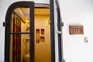 an open door with a mirror in a room at The General's House - Tranquility Garden Villa in Hanoi