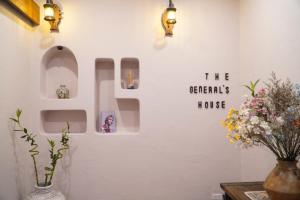 a wall with a sign that reads the chemicals house at The General's House - Tranquility Garden Villa in Hanoi