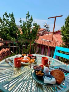 a table with a tray of breakfast food on it at Erkal Pension in Antalya