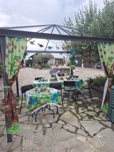 a table and chairs under a tent with a table and chairs at Cascina Tesoriera in Santhià