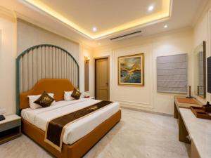 a bedroom with a large bed and a television at Hotel De - Grand Villa Near Delhi IGI Airport in New Delhi +15 photos