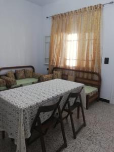a living room with a table and a couch at Furnished accommodation S2 in Nabeul in Nabeul
