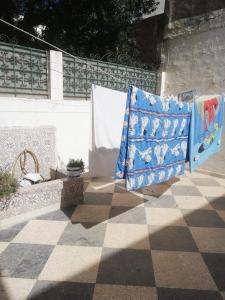 a patio with a bench and a blanket on a wall at Furnished accommodation S2 in Nabeul in Nabeul