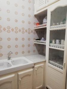 a bathroom with a sink and a mirror at Furnished accommodation S2 in Nabeul in Nabeul