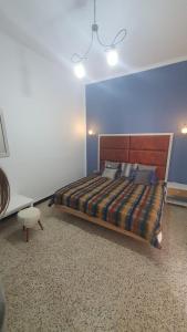 a bedroom with a bed and a blue wall at Furnished accommodation S2 in Nabeul in Nabeul