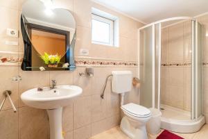 a bathroom with a sink and a toilet and a mirror at Casa Buga in Telega +16 photos