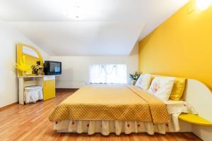 a bedroom with a bed and a yellow wall at Casa Buga in Telega