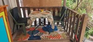 a table and two chairs on a balcony at Le P'tit gîte in Saint-Privat +5 photos