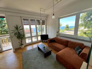 a living room with a couch and a table at Sea Breeze - Barcola - Trieste Reception in Trieste +42 photos