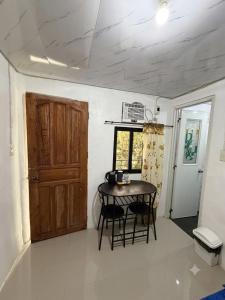 a small room with a table and a door at D Haven Space Rental in La Carlota