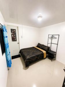a bedroom with a bed in a white room at D Haven Space Rental in La Carlota