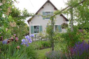 a house with a garden in front of it at Côté gartempe in Les Hermitières