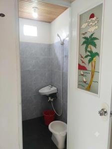 a bathroom with a toilet and a sink at D Haven Space Rental in La Carlota +15 photos